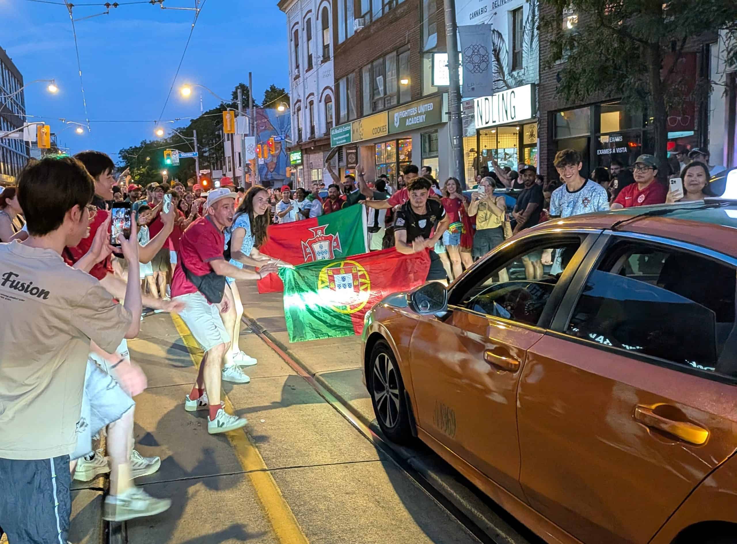 Portuguese fans celebrate on Dundas Street after a thrilling 2-1 round-of-32 World Cup knockout game in Toronto.